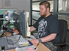 Michael Thölken an seinem Arbeitsplatz mit Bildschirm, Tastatur und Headset beim Bügertelefon Bremen