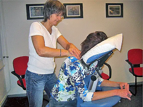 Masseurin massiert eine Beschäftigte